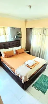 a large bed in a room with a mirror at Sol Mar Alegre II in Boca Chica