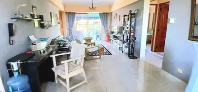a living room with a counter and chairs in it at Sol Mar Alegre II in Boca Chica