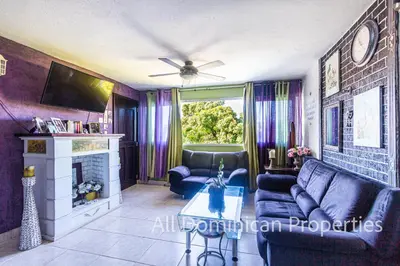 a living room with a couch and a fireplace at Unusual Artist's Loft with jacuzzi and Roof Terrace in Sosúa