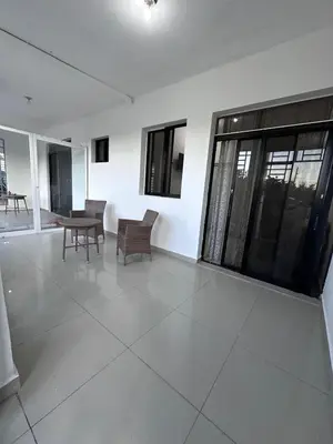 a living room with chairs and a table and windows at Apartahotel-E vista catalina in La Romana