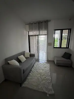 a living room with a couch and a window at Apartahotel-E vista catalina in La Romana