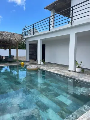 a swimming pool in front of a house at Apartamento Entre Playas 1 - 3 pax, 4 min de la playa in Las Galeras