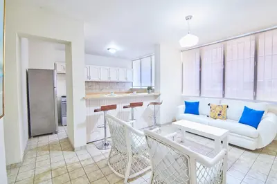 a living room with a couch and a table at A Beautiful Studio Apartments Furnished in Gascue in Santo Domingo