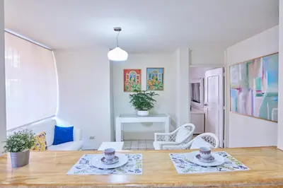 a living room with a table and chairs at A Beautiful Studio Apartments Furnished in Gascue in Santo Domingo