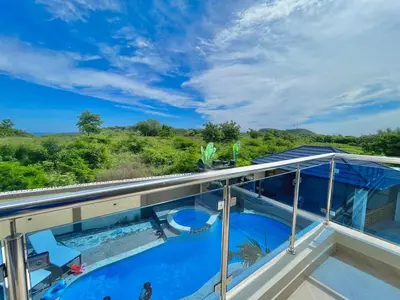 a view from the balcony of a house with a swimming pool at Villa VP One - Punta rucia beach in Punta Rucia