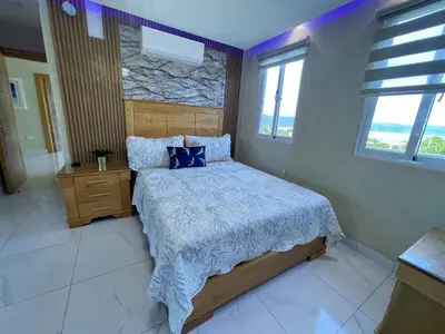 a bedroom with a bed with blue pillows at Villa VP One - Punta rucia beach in Punta Rucia