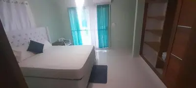 a bedroom with a white bed and a window at Luxury in Cabarete