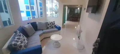 a living room with a blue couch and a fan at Luxury in Cabarete