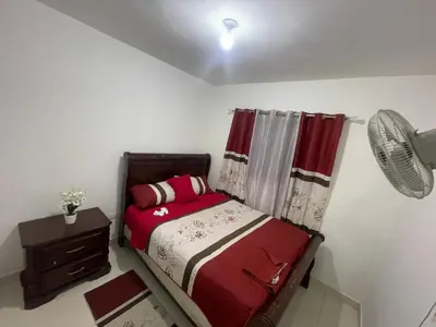 a small bedroom with a bed and a window at Antare ll edificio 52 A3 in Santo Domingo