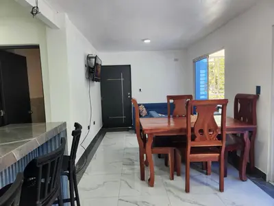 a dining room with a wooden table and chairs at Apartment in front of beach, AC, Wifi, Hot Water in Paraíso