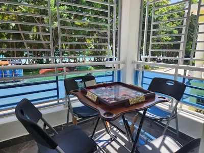 a table and chairs in a room with windows at Apartment in front of beach, AC, Wifi, Hot Water in Paraíso