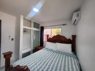 a bedroom with a bed and a window at Apartment in front of beach, AC, Wifi, Hot Water in Paraíso