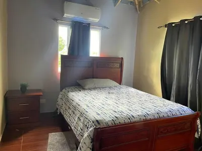 a bedroom with a bed and a window at Casa lopez in Jarabacoa