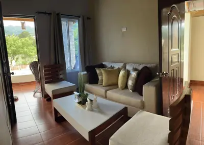 a living room with a couch and a table at Casa lopez in Jarabacoa