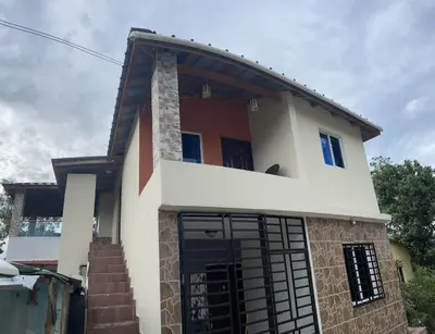 a house with a gate in front of it at Casa lopez in Jarabacoa