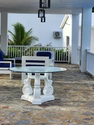 a white table and chairs on a patio at Bella Villa room with kitchenette, pool and close to the beach in Las Galeras in Las Galeras