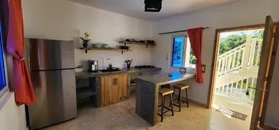 a kitchen with a stainless steel refrigerator and a counter at Bella Villa Apart for 2 with kitchen pool and close to the beach in Las Galeras
