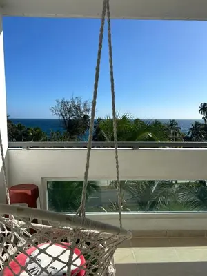 a swing in a room with a view of the ocean at Gran Apartamento frente al mar in La Francia