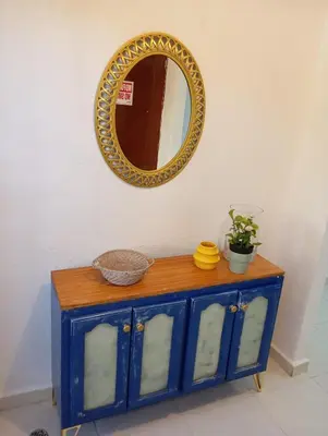 a blue cabinet with a mirror on a wall at Ciudad Juan Bosch StoDgo este in La Javilla