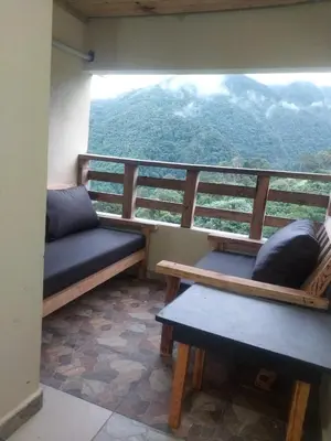 a balcony with benches and a view of a mountain at Vista Montaña Jimenoa de la Rosa in Jarabacoa