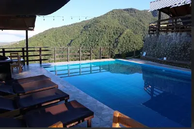 a swimming pool with a view of a mountain at Vista Montaña Jimenoa de la Rosa in Jarabacoa
