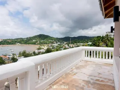 a white balcony with a view of the ocean at Villas Hillside apt 4 in Santa Bárbara de Samaná