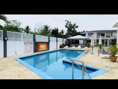 a large swimming pool with blue water in a yard at Kasita del sol boca chica in Boca Chica