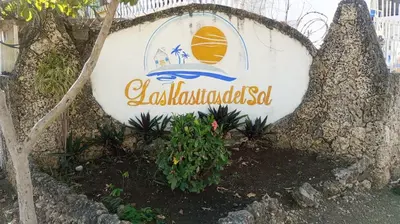a sign for a resort on the side of a building at Kasita del sol boca chica in Boca Chica