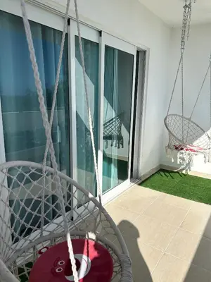 a swing on the balcony of a house at Vista al Caribe in La Francia