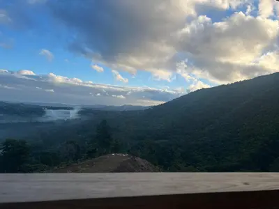 a view of a valley from a mountain with trees at Vista Montaña Jimenoa De La Rosa in Jarabacoa