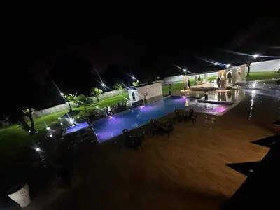 an empty swimming pool at night with lights at Villa Canaan in Pedro Brand