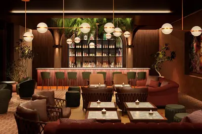 a restaurant with couches and tables and a bar at Fiesta Americana Funeeq Punta Cana All Inclusive in Punta Cana