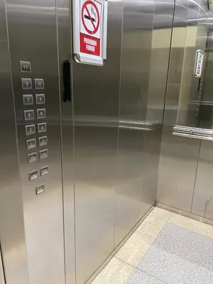 a metal elevator with a no smoking sign on it at Charming space in the city center in Santo Domingo