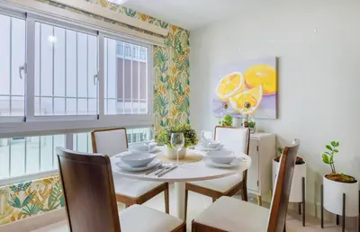 a dining room with a white table and chairs at Charming space in the city center in Santo Domingo