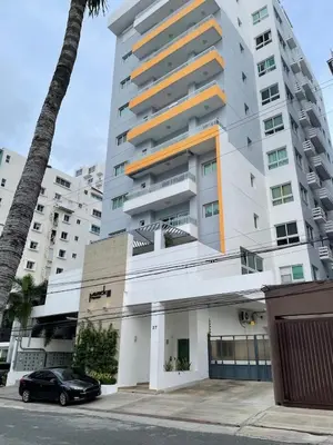 a black car parked in front of a tall building at Charming space in the city center in Santo Domingo