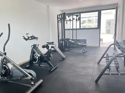 a gym with several tread machines in a room at Amazing pool views apartment in Playa Bavaro in Punta Cana