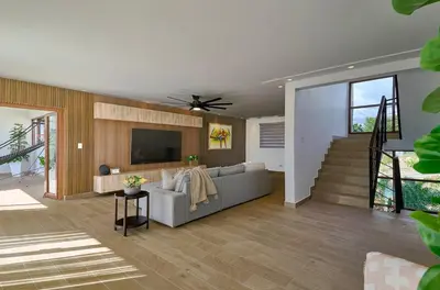 a living room with a couch and a flat screen tv at Villa La Chiquita Paradise Pool and BBQ in Baní
