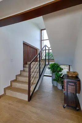 a staircase in a house with a wooden floor at Villa La Chiquita Paradise Pool and BBQ in Baní
