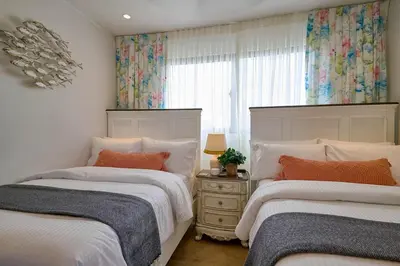 a bedroom with two beds and a window at Villa La Chiquita Paradise Pool and BBQ in Baní