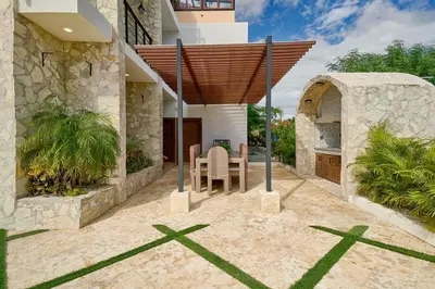 a house with a table and chairs in the yard at Villa La Chiquita Paradise Pool and BBQ in Baní