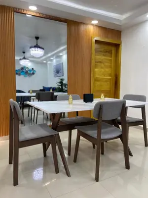 a dining room with tables and chairs and a door at Modern, Unique And Stylish 1 Bedroom Apartment in San Pedro de Macorís