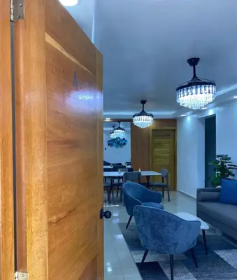a door leading to a dining room with a table at Modern, Unique And Stylish 1 Bedroom Apartment in San Pedro de Macorís