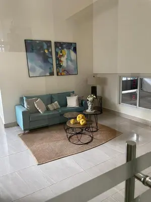 a living room with a blue couch and a table at La Condesa del Vergel in Santo Domingo