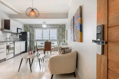 a kitchen and living room with a couch and a table at La Condesa del Vergel in Santo Domingo