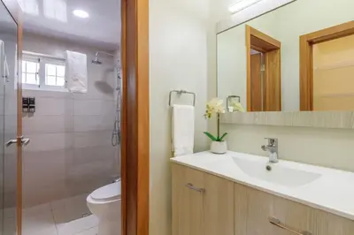 a bathroom with a sink and a toilet and a mirror at La Condesa del Vergel in Santo Domingo