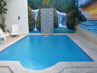 a swimming pool with a painting on the wall at RGgrup in Pantoja
