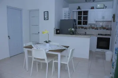 a kitchen with a table and chairs in a kitchen at RGgrup in Pantoja