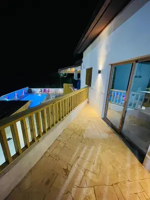 a balcony of a house with a swimming pool at Villa Estela Jarabacoa in Jarabacoa