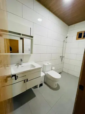 a bathroom with a toilet and a sink at Villa Estela Jarabacoa in Jarabacoa