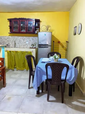 a kitchen with a table and chairs and a refrigerator at Rincón del Mojito in Santa Cruz de Barahona